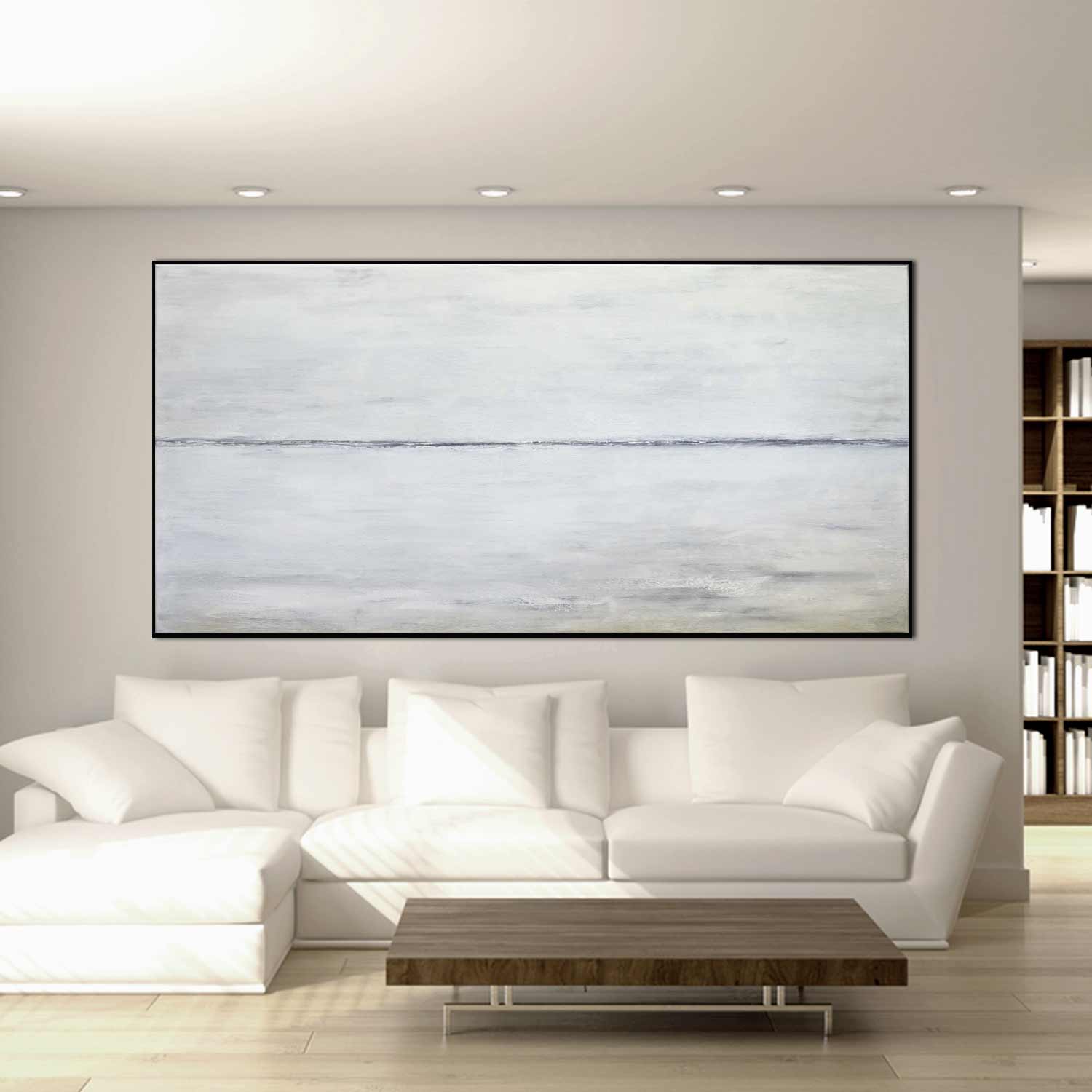 Modern living room with a white sofa, wooden coffee table, and large abstract painting on the wall.