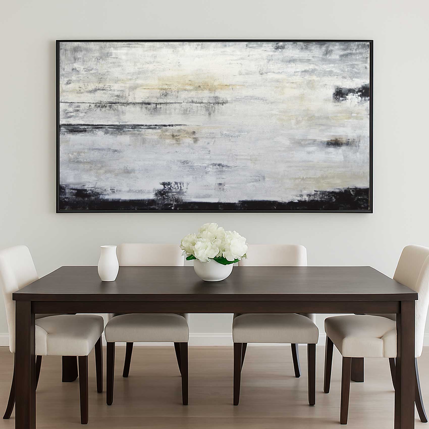 Dining room with a dark wooden table and chairs, white flowers in a bowl, and abstract art on the wall.
