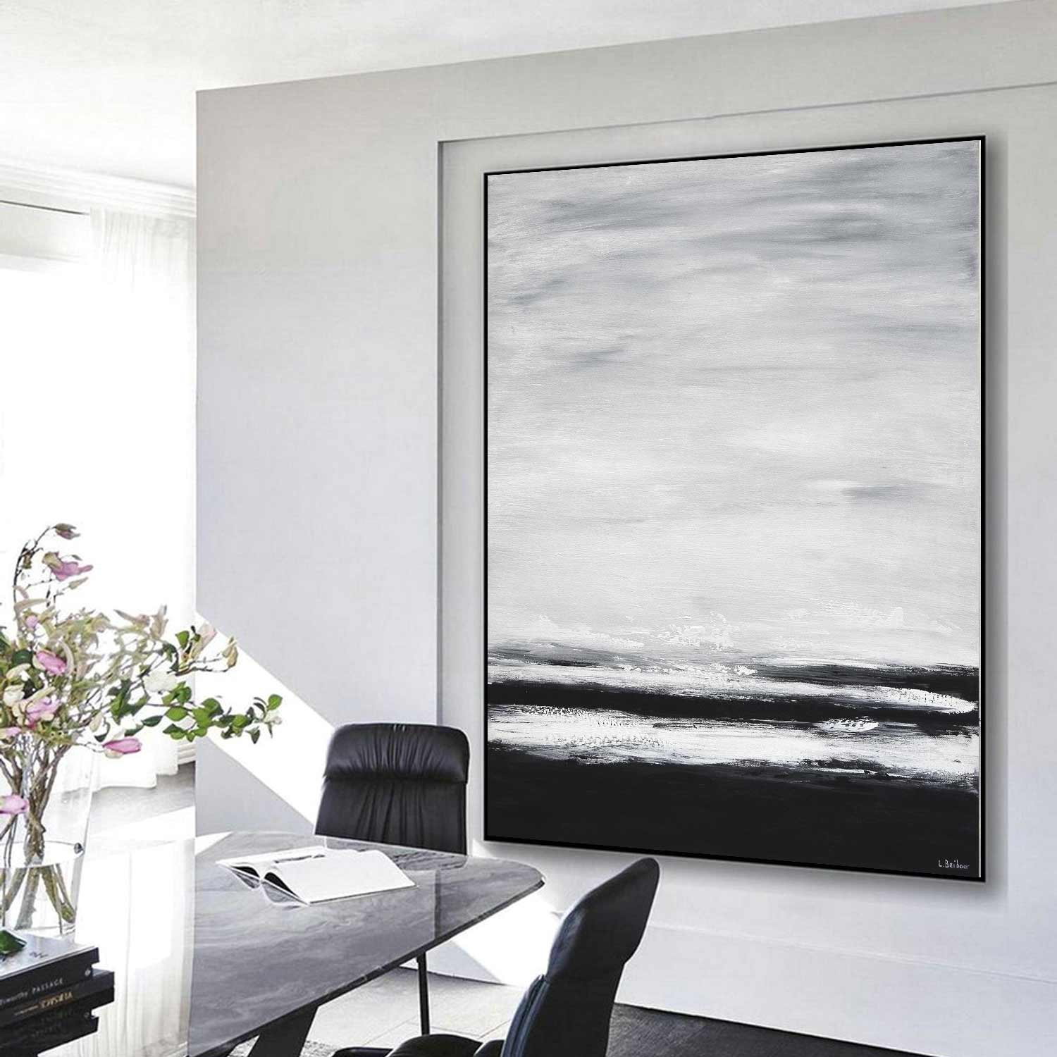 Abstract black and white painting on a wall in a modern interior setting.