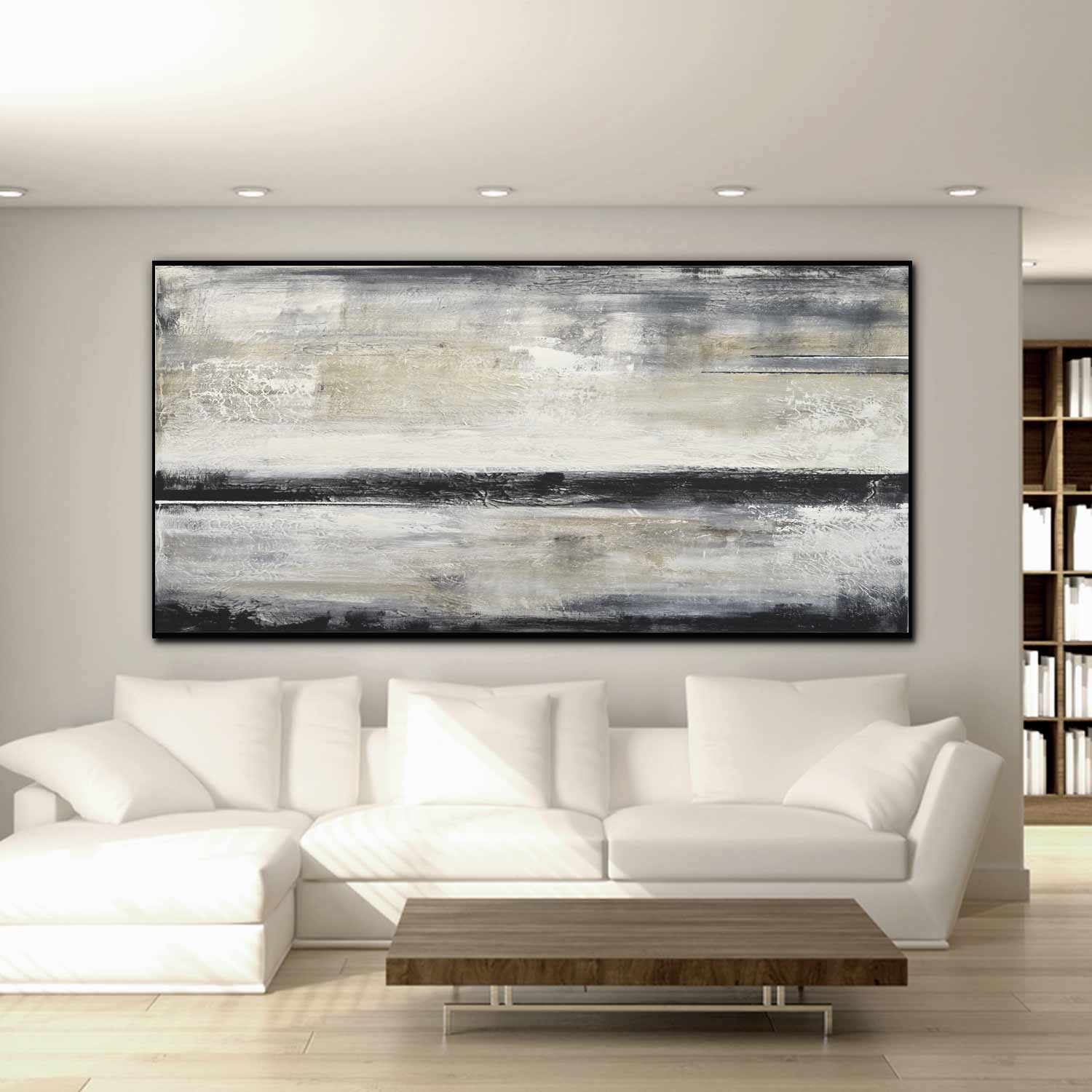 Abstract painting on a wall above a white sofa in a modern living room.