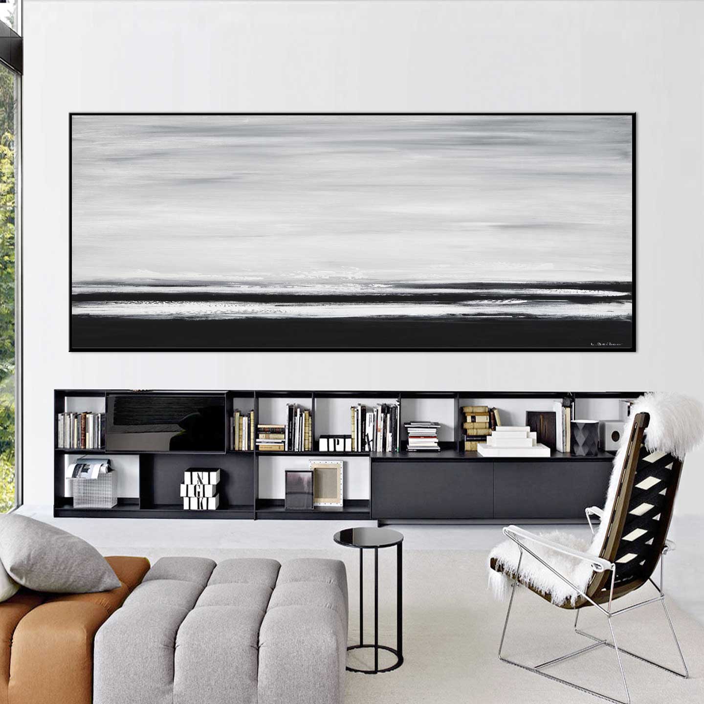 Modern living room with a large abstract painting on the wall and a bookshelf below.