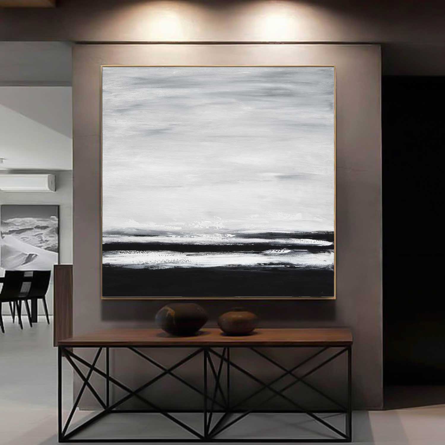 Abstract artwork in a modern interior setting with a wooden console table.