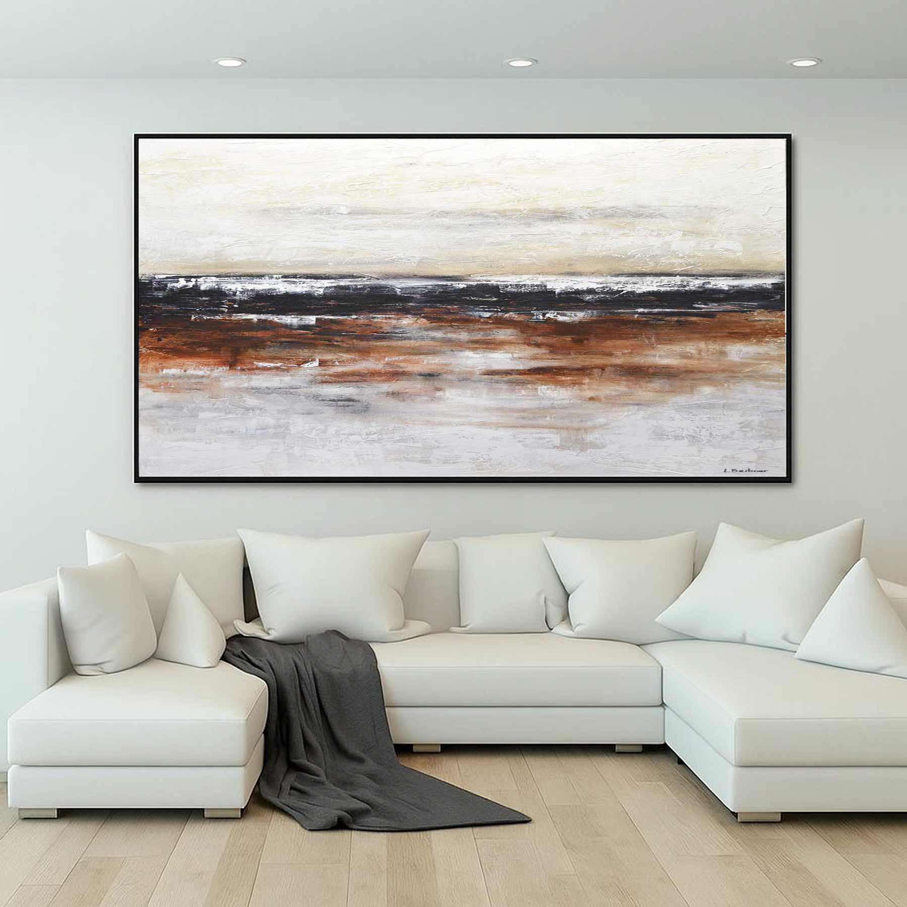 Large abstract painting on a wall above a white sectional sofa in a living room.